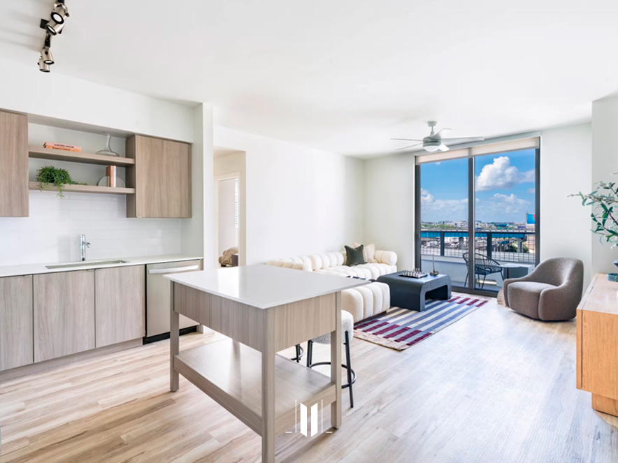 Modern living room in Modera Riverside apartment with minimalist furniture and large city view window