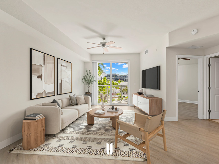 Bright and spacious living room at SOMA at Brickell with beige sofa and contemporary decor
